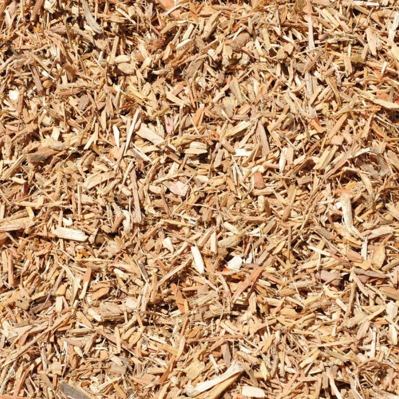 Close-up of wood chips or mulch with a brown color.